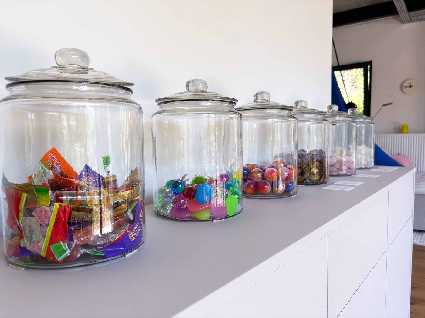Bunte Süßigkeitengläser auf dem Sideboard in der Praxis